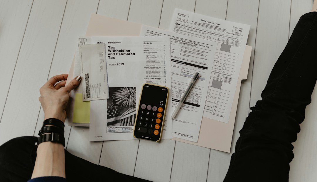 Paper finance records, calculator and person checking figures illustrating Gemini financial insights and spreadsheet verification