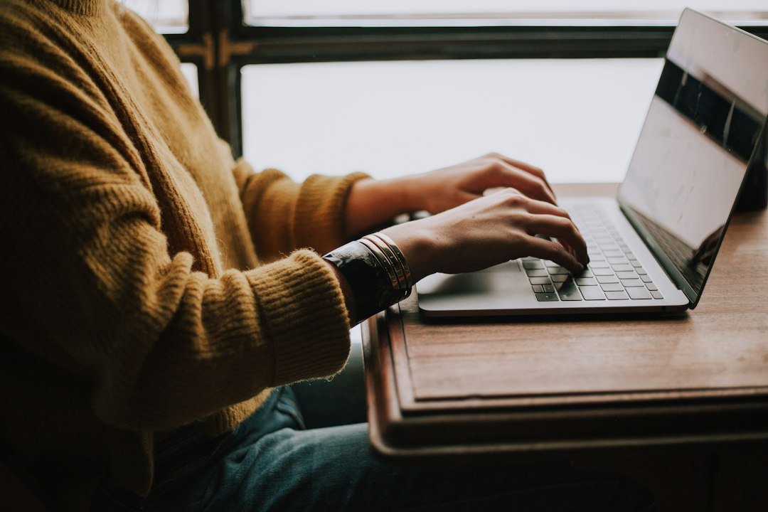 Person typing on laptop, illustrating multi-step Gemini auto browse in Chrome on desktop, editorial concept photograph