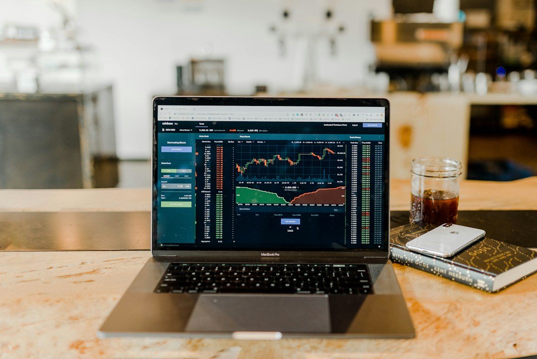 Trader working with financial price charts at a laptop, editorial conceptual image illustrating share sale margin and SEBI early pay-in rules