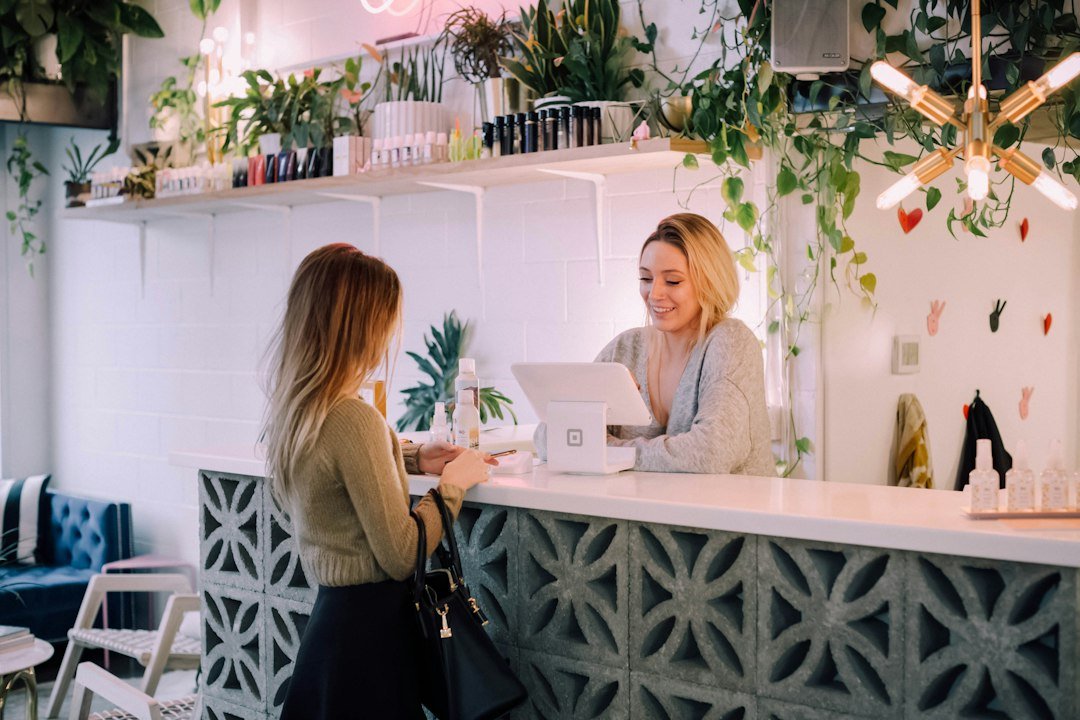 Small business shop operator serving customers with digital technology representing Meta AI productivity survey