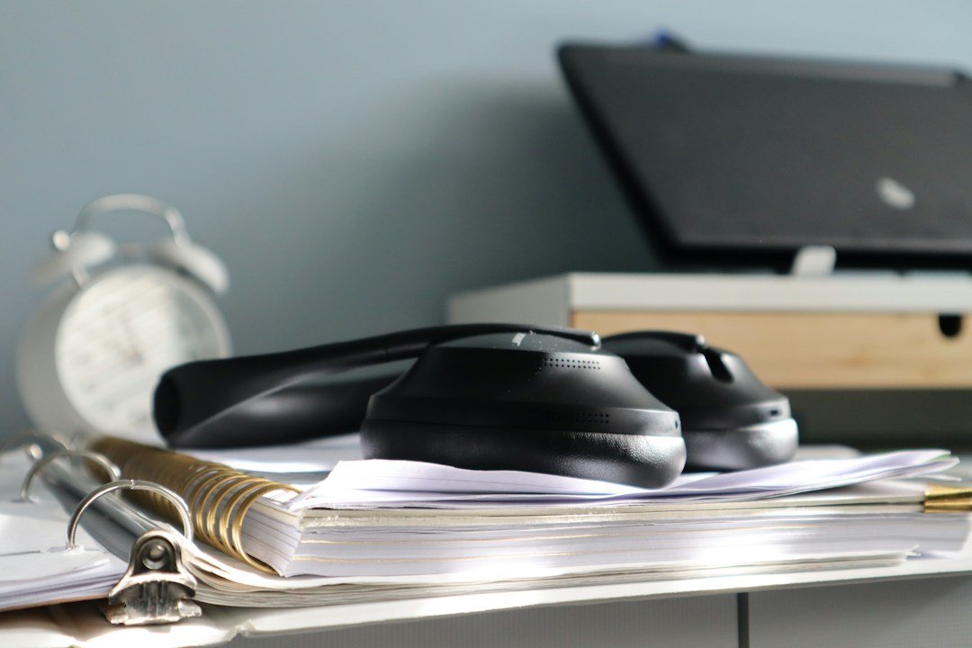 Office desk with smartphone and laptop, illustrative image for institutional research analyst client communications and record retention