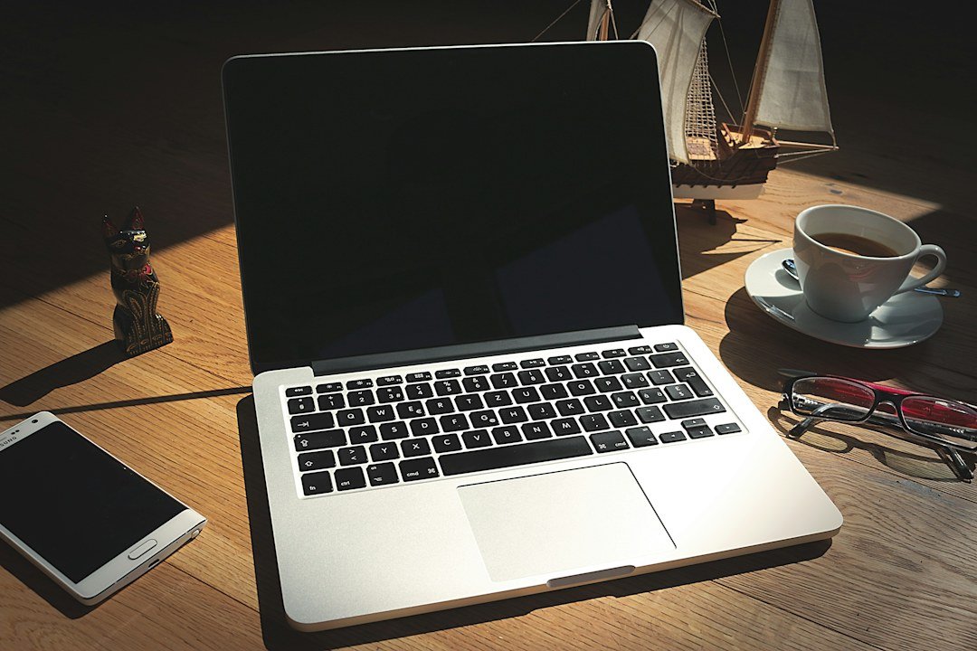 Phone and notebook on a desk symbolizing cautious verification of AI-generated financial advice and deepfake investment messages